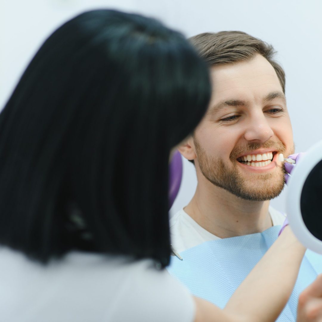 Dental care concept. Handsome young guy at the dentist's office